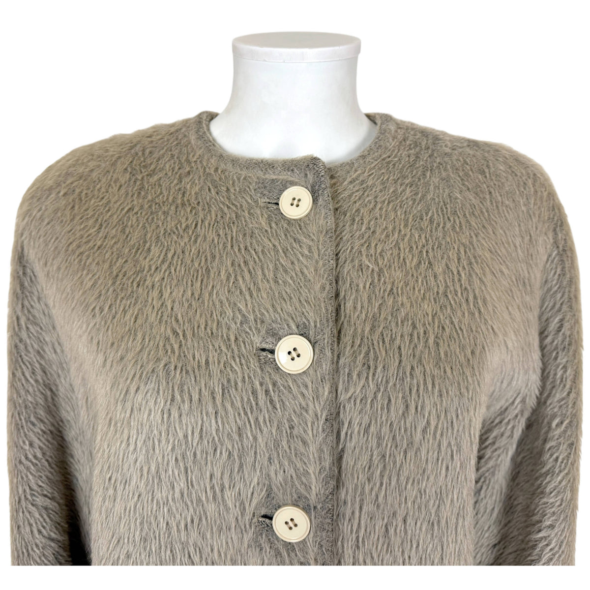 Close-up of Gianfranco Ferré alpaca wool coat showing collarless neckline, cream buttons and textured nap