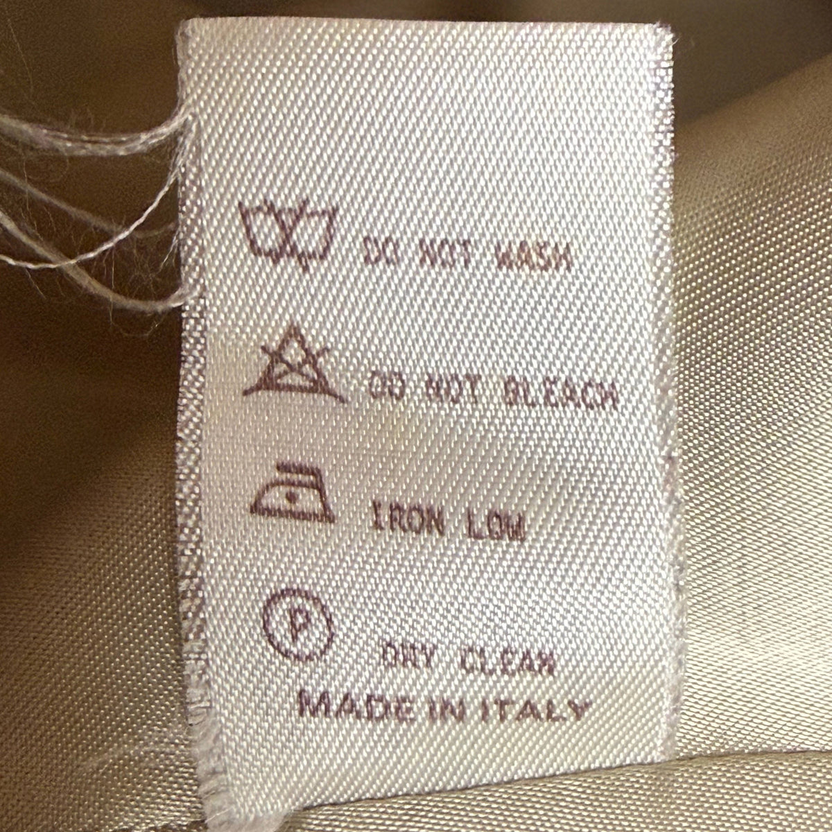 Care label inside vintage Italian Gianfranco Ferré alpaca wool coat with dry-cleaning instructions