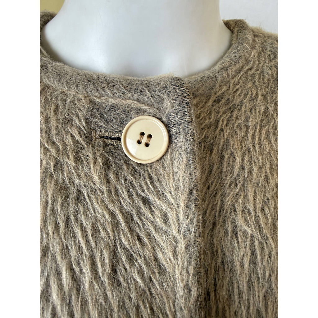 Close-up of alpaca wool coat neckline and top button showing textured fabric and areas of nap wear