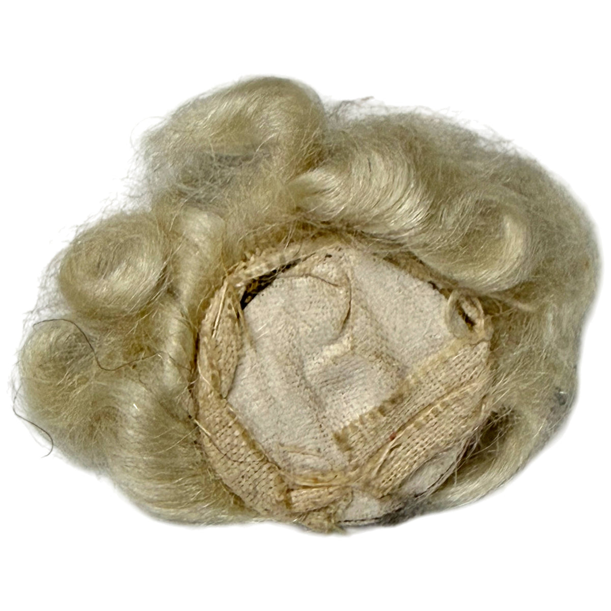 Reverse of antique Art Deco fabric face appliqué showing rigid fabric backing, original stitching and blonde wig construction