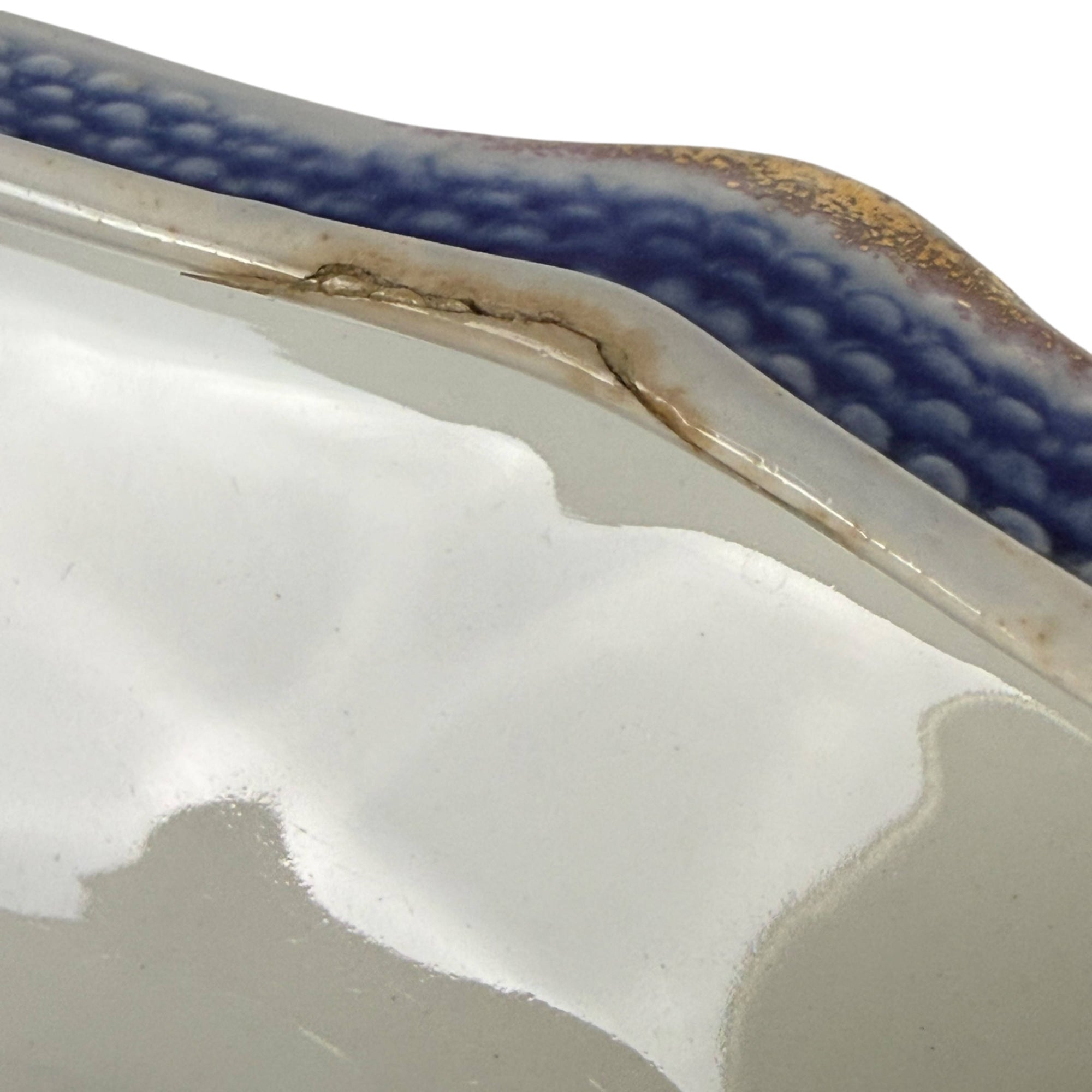 Repair to interior edge of bowl