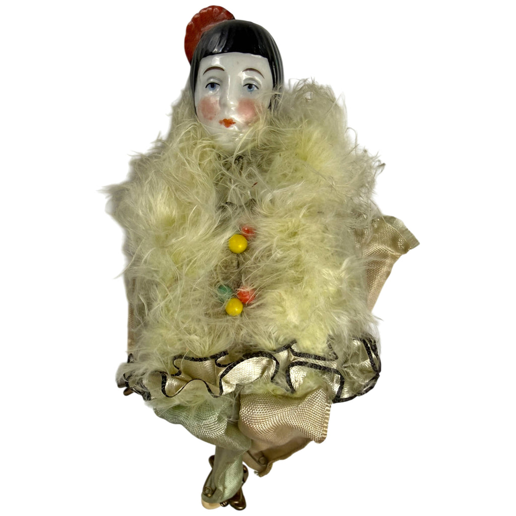 Front view of antique Pierrot pincushion doll with cream feather trim and gathered ribbon edging