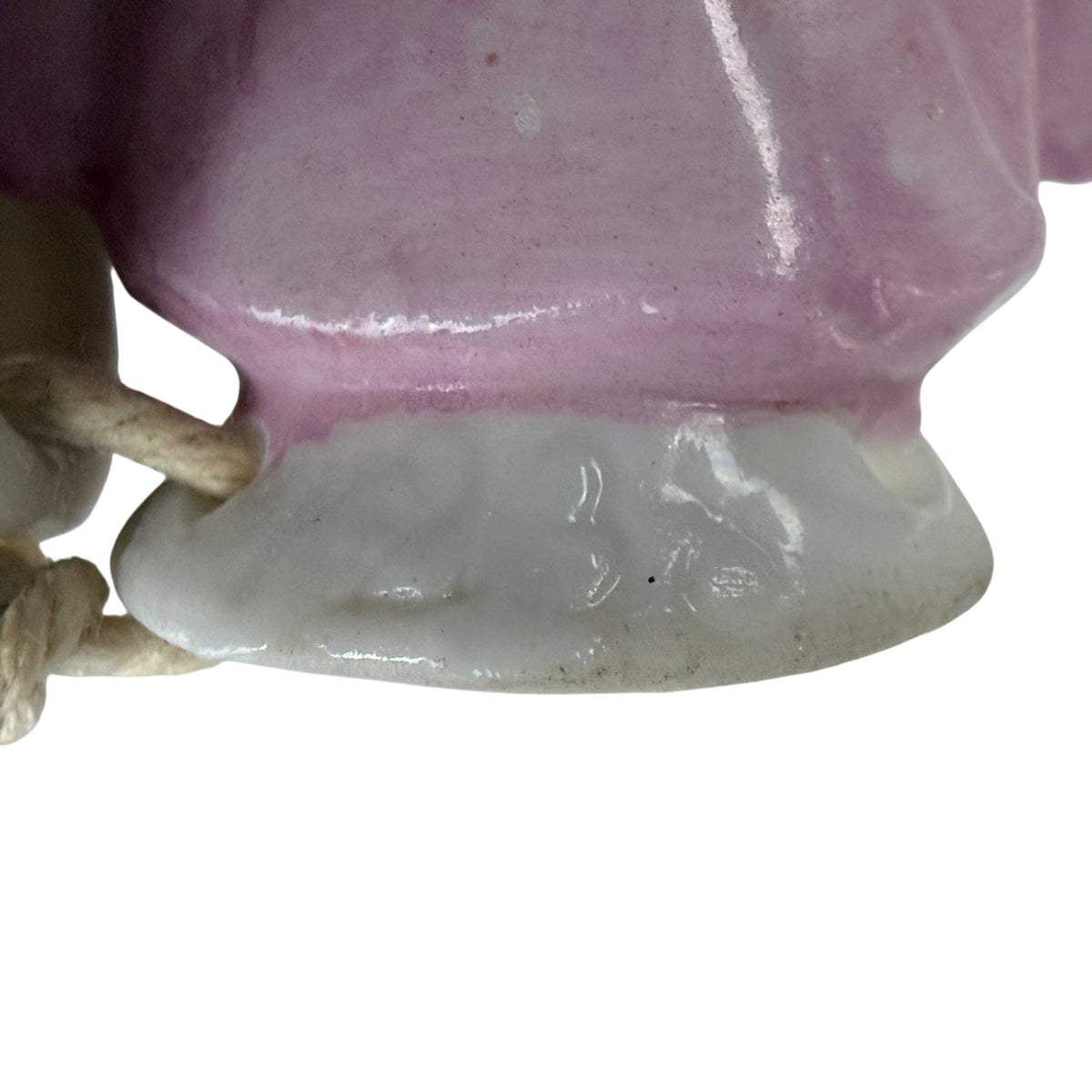 Close-up of faint impressed numerical marking on back of antique German porcelain half doll base