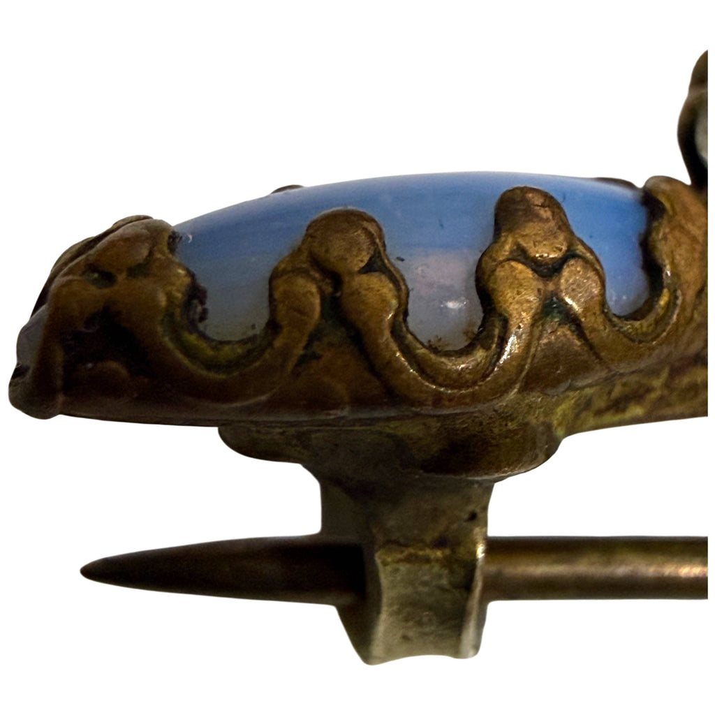 Side view of antique Victorian opal glass brooch showing brass-coloured prong setting and old pin stem