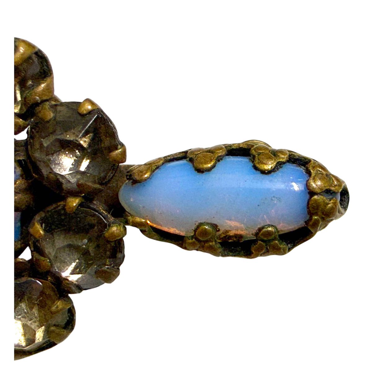 Detail of elongated blue opal glass cabochon and surrounding paste rhinestones on Victorian bar brooch
