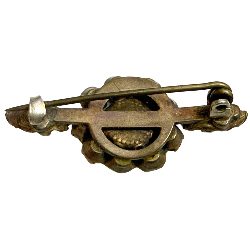 Reverse of antique Victorian bar brooch showing openwork metal construction, long pin stem and hook catch