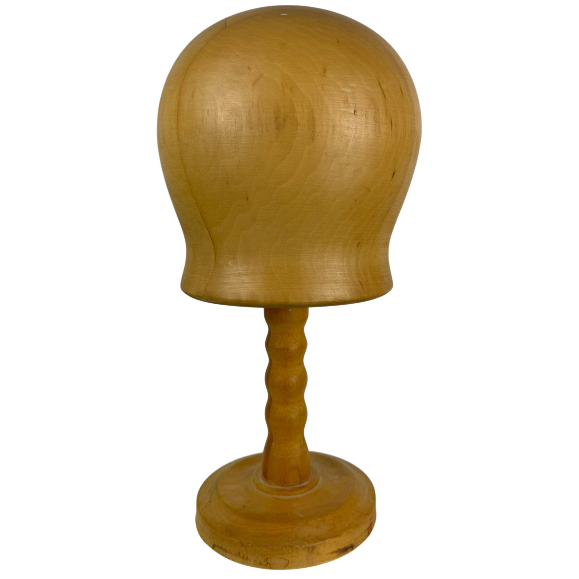 Side view of wooden hat block on stand