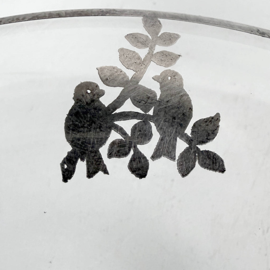 Detail of bird motif silver decoration on vintage Heisey bowl
