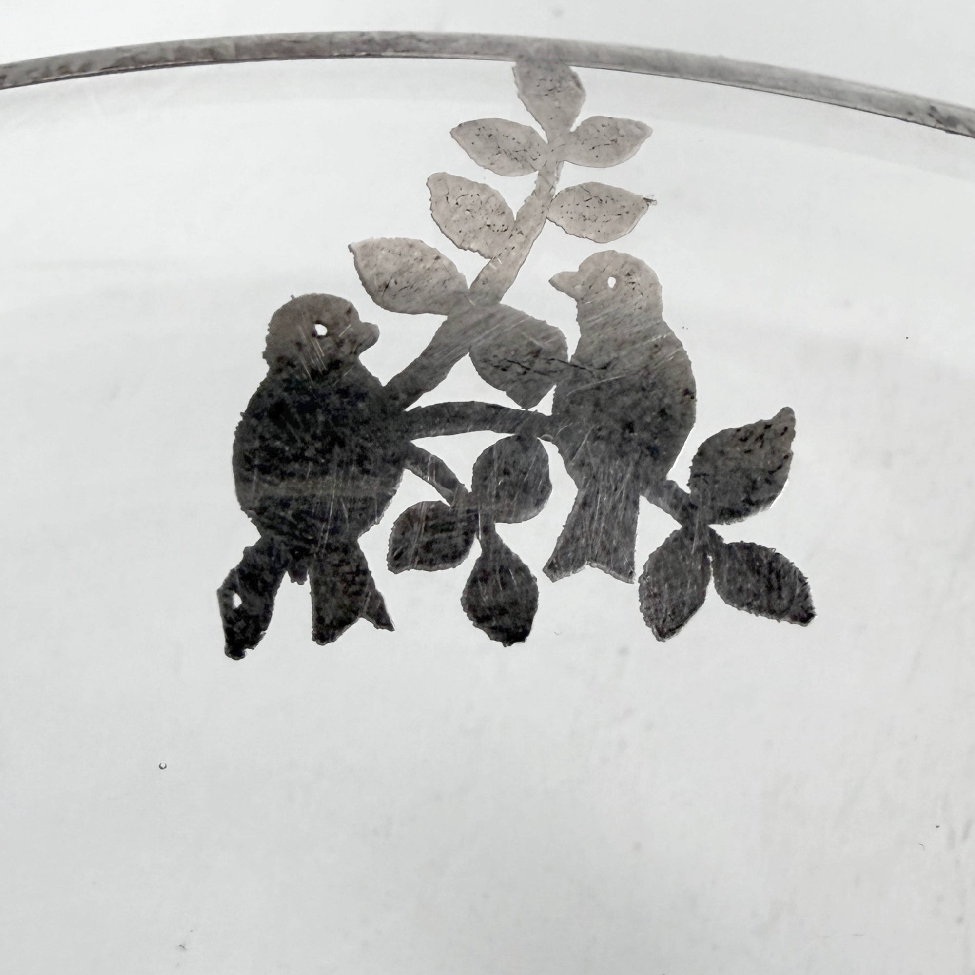 Detail of bird motif silver decoration on vintage Heisey bowl