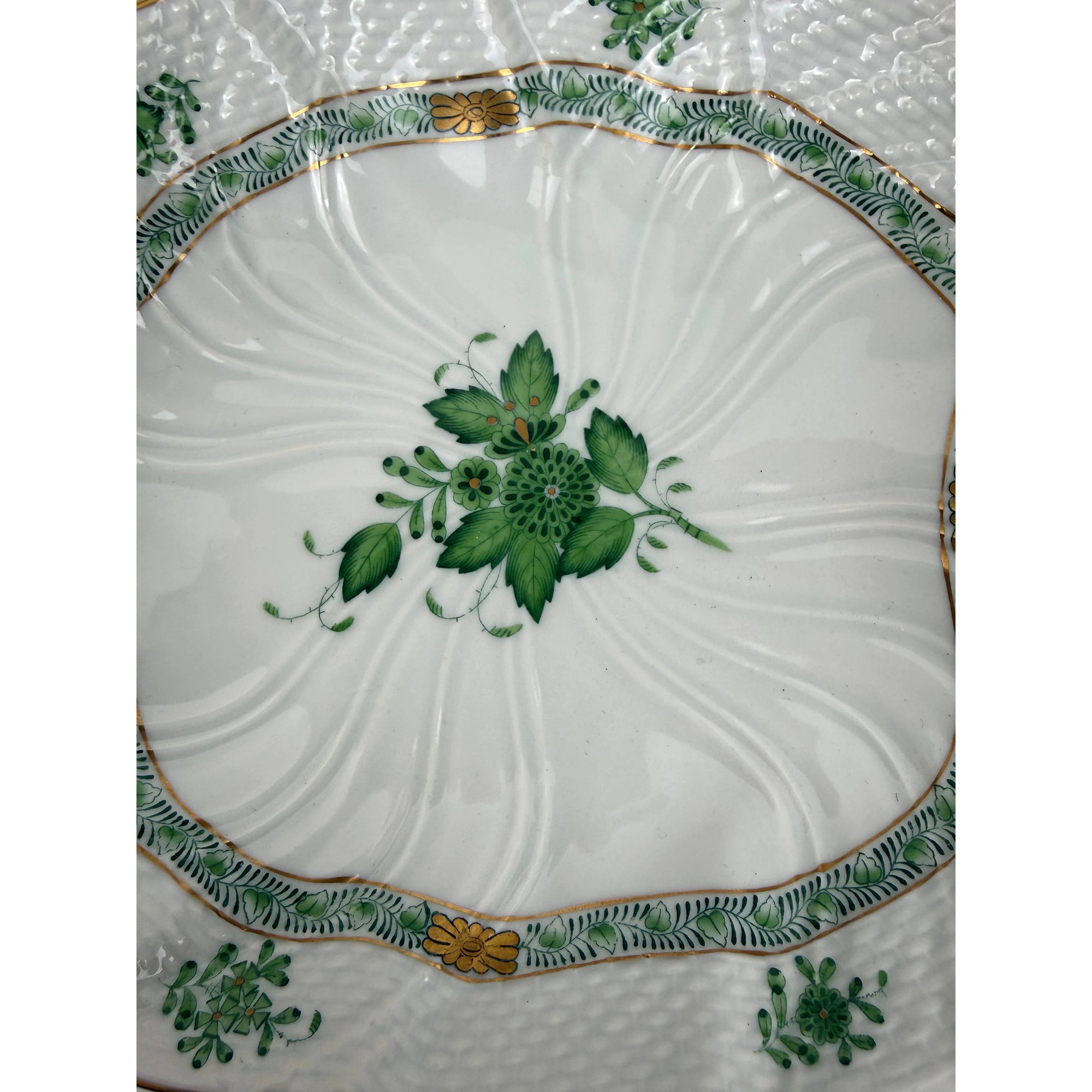 Close up of Herend green floral spray and gilt border