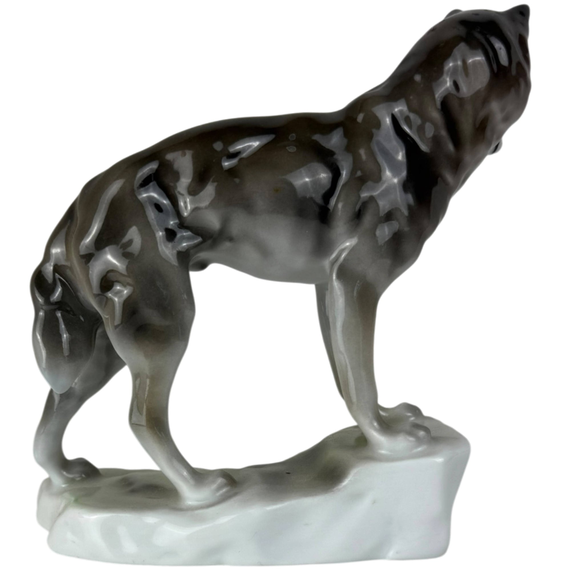 side view of wolf on rock porcelain figurine