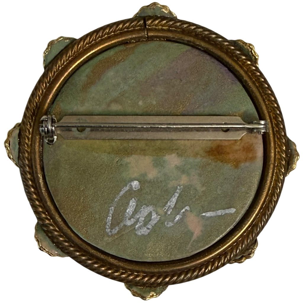 Reverse of vintage artisan brooch showing pin and hand-painted signature