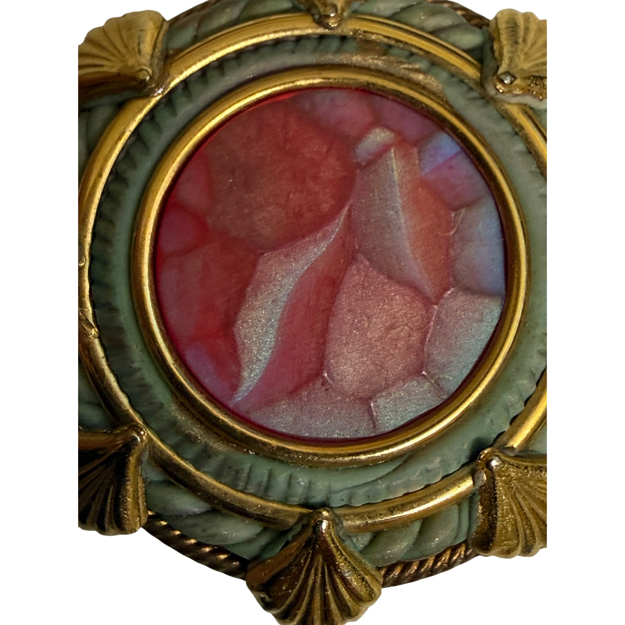 Close-up of faceted red moulded glass centre and sage-green border