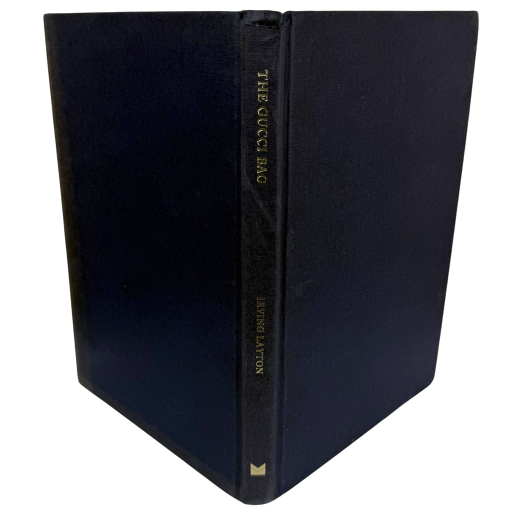 A hardcover book titled 'The Gucci Bag' by Irving Layton, featuring a dark navy blue textured cover and gold lettering on the spine