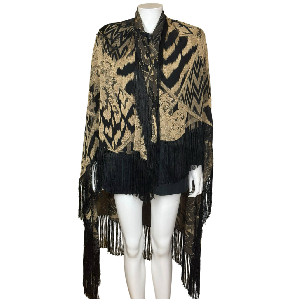 Large Italian silk jacquard shawl draped over shoulders showing black fringe and contrasting gold floral and geometric motifs