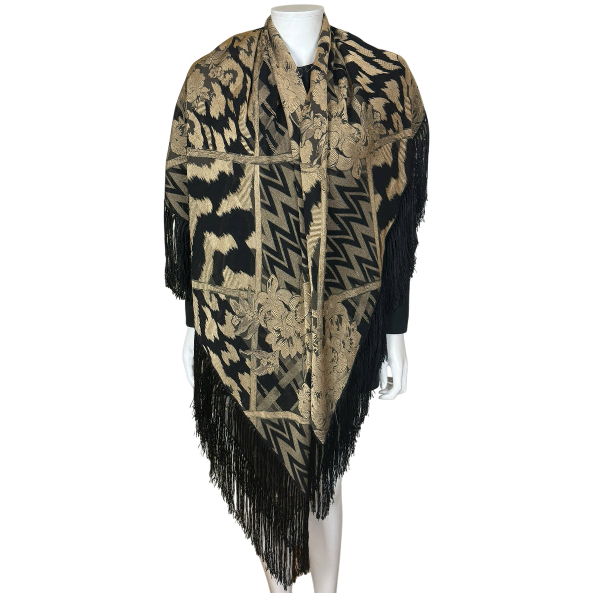 Vintage black and gold Italian jacquard shawl folded into a triangular wrap with long fringe along the pointed hem