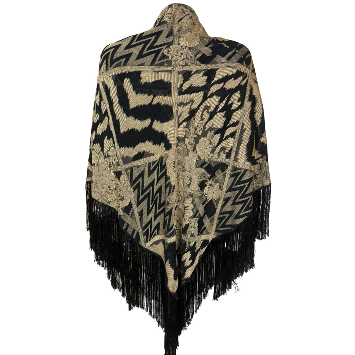 Back view of black and antique gold Italian jacquard shawl folded into a triangle with floral motifs and fringed pointed hem