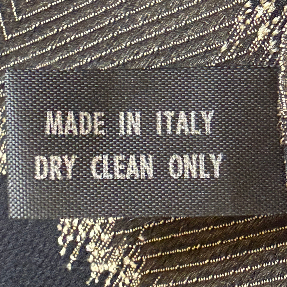 Reverse of vintage Italian shawl label reading Made in Italy and Dry Clean Only