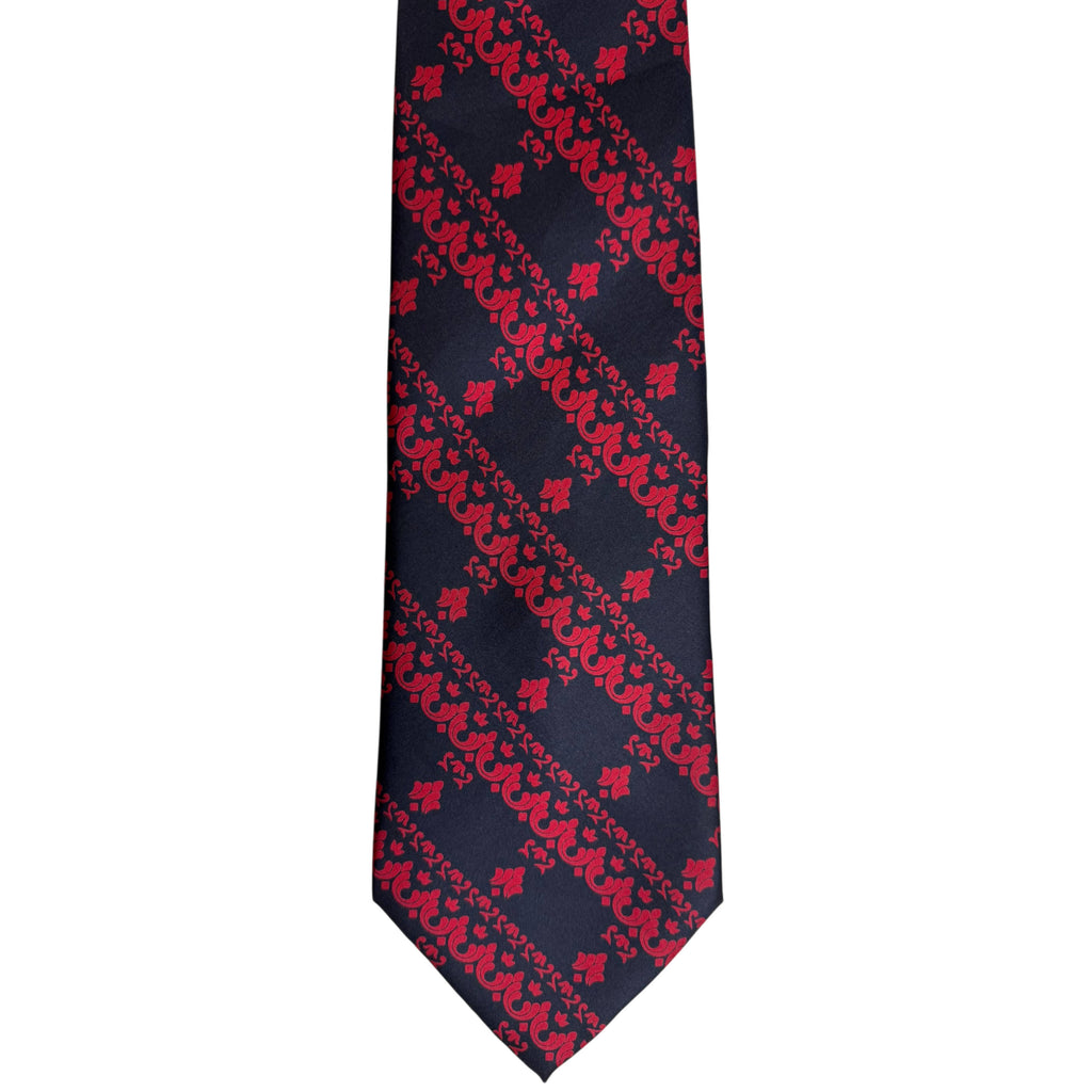 Close-up of wide pointed blade of 1970s Jacques Fath silk necktie showing red floral and scrollwork design