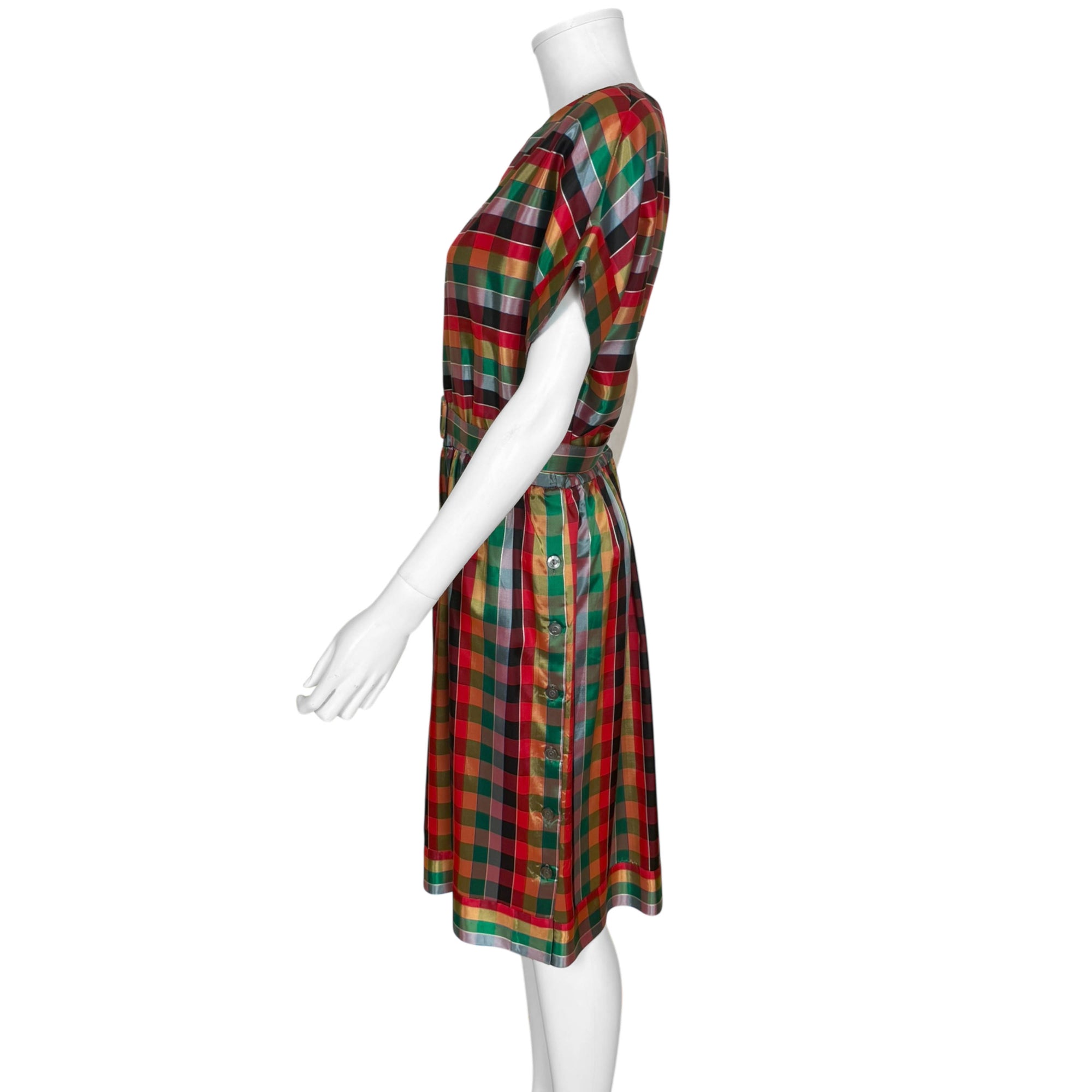 Side view of 1970s plaid party dress with button detail and draped skirt