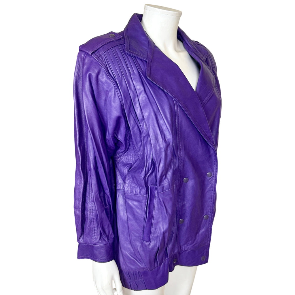Three-quarter view of Jez Montréal purple leather jacket with wide lapels, shoulder epaulettes and front pockets
