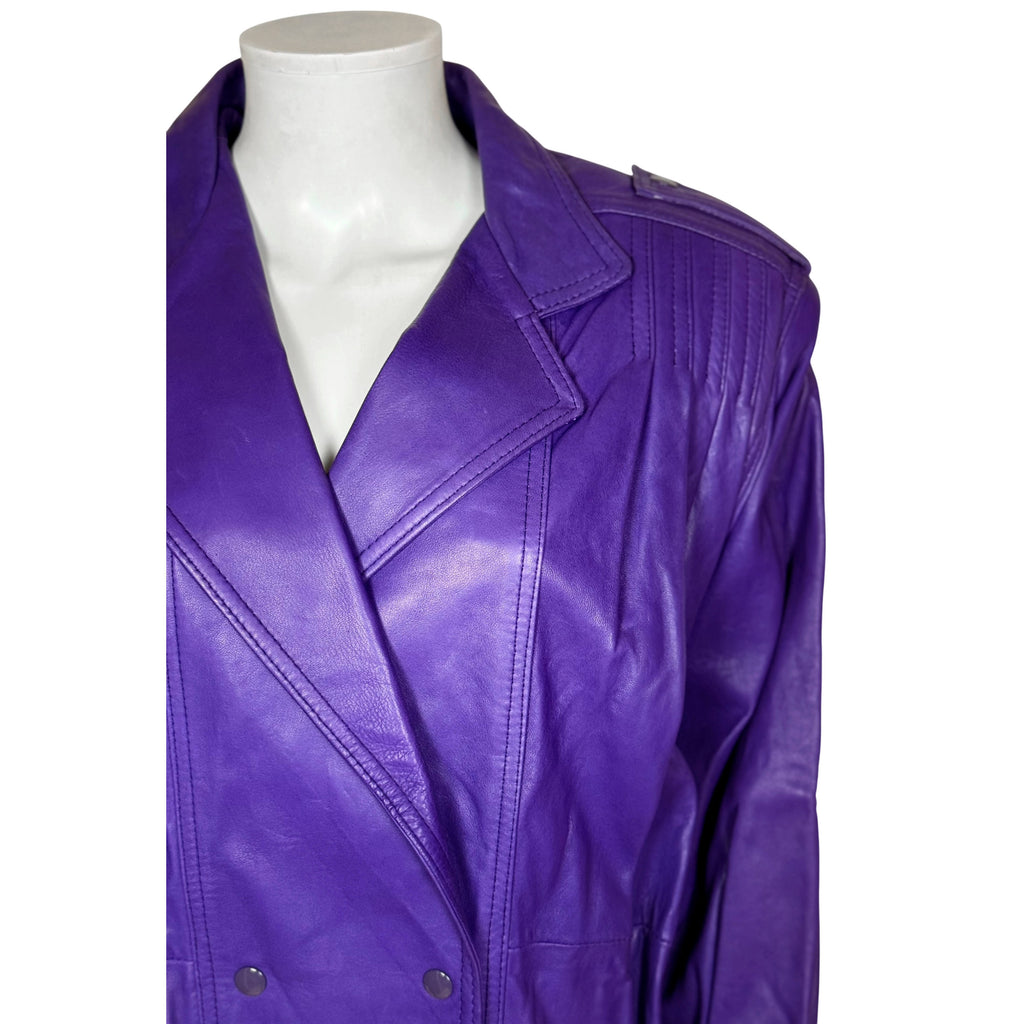 Close-up of vibrant purple leather jacket showing broad notched lapels, stitching and snap fasteners