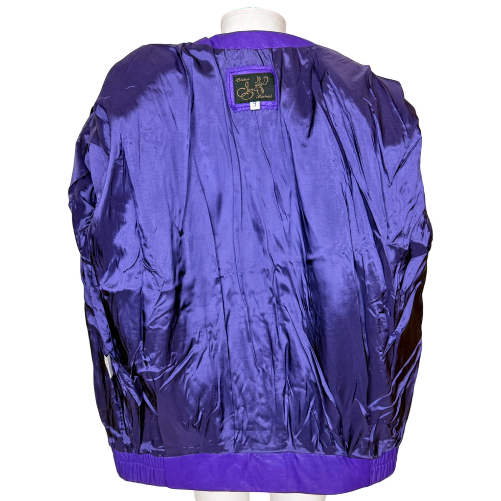 Interior of vintage Jez Montréal leather jacket showing coordinating purple acetate lining and designer label