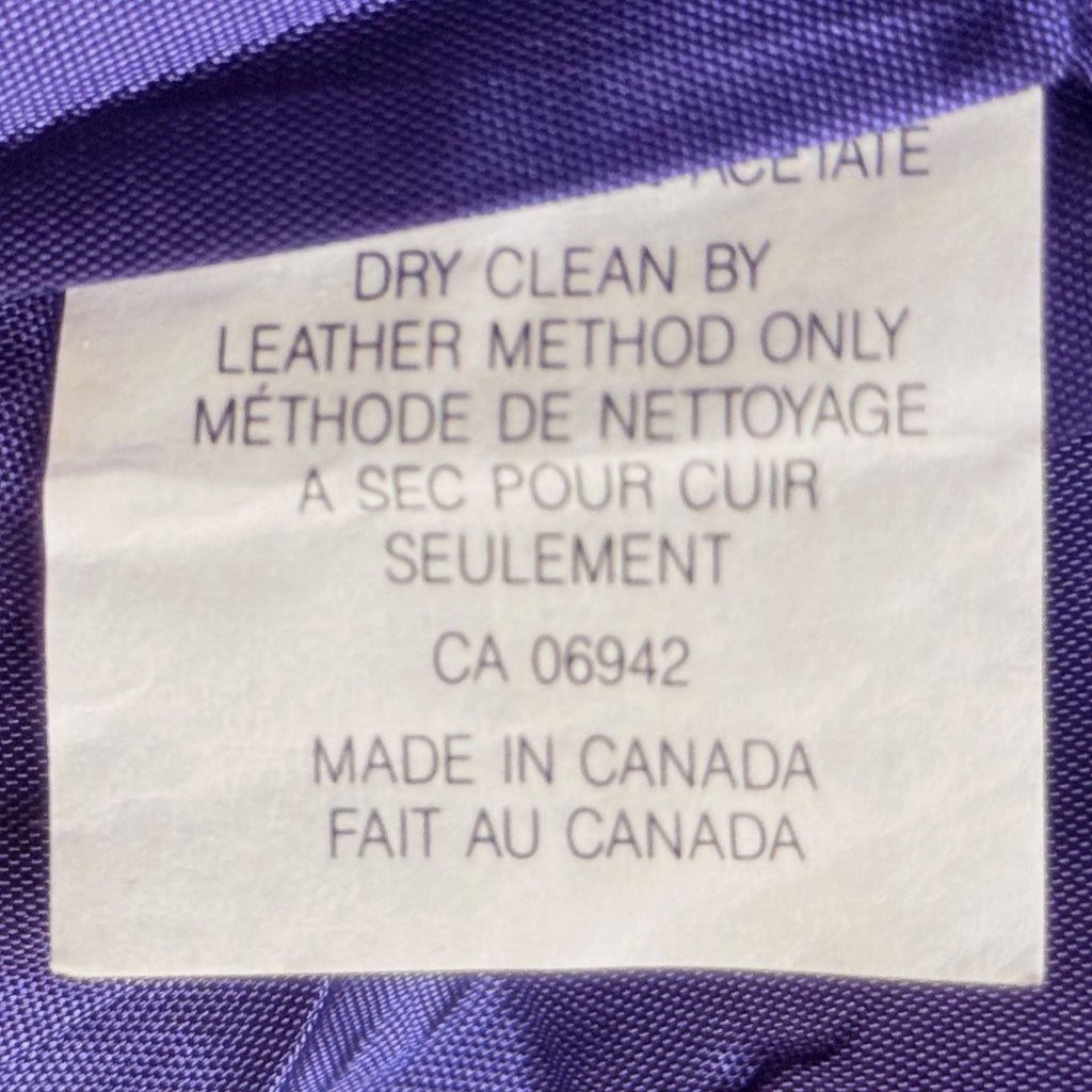 Original care label confirming Made in Canada and leather-specific dry-cleaning instructions.