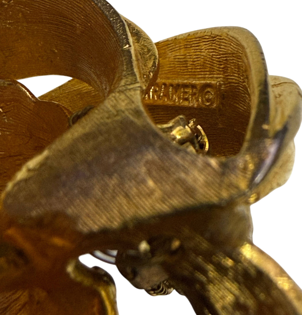 Close-up of signed KRAMER © maker's mark on reverse of vintage lily brooch