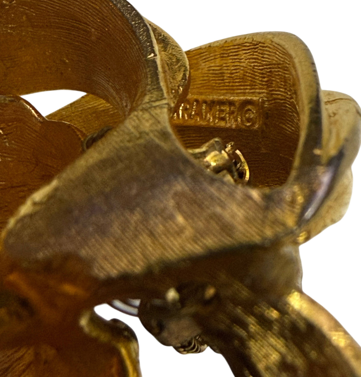 Close-up of signed KRAMER © maker's mark on reverse of vintage lily brooch