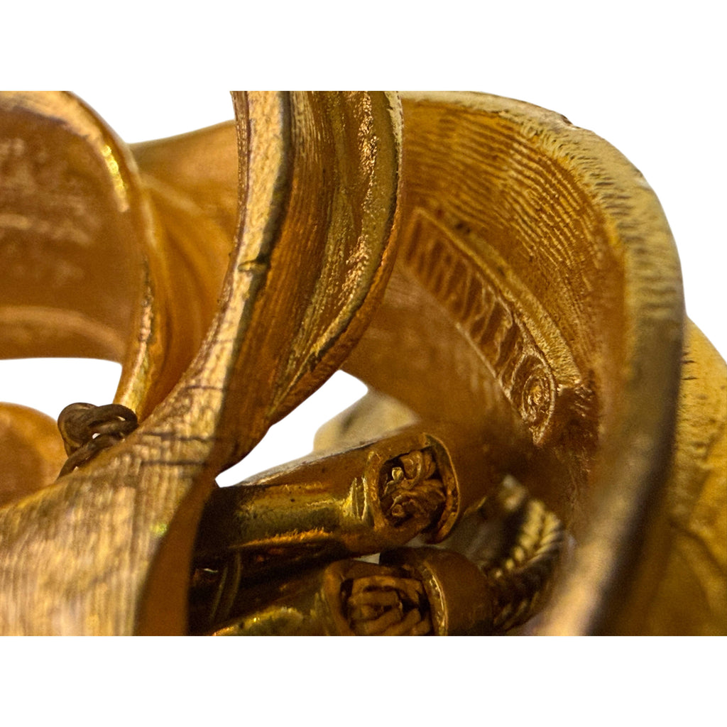 Close-up of copyright Kramer signature and tassel attachments on reverse of gold-tone brooch
