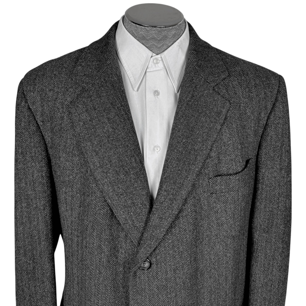 Close-up of Cardinal men's Kynoch herringbone wool overcoat showing notched lapels, breast pocket and fine weave