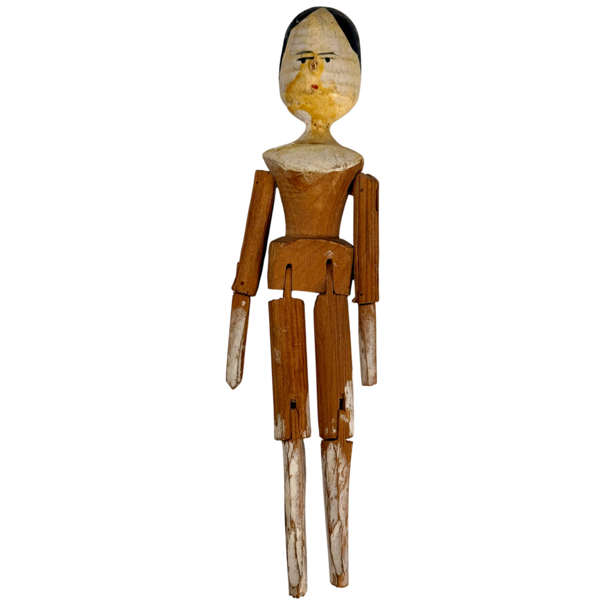 Antique German Grödnertal wooden peg doll with hand-painted face, jointed wooden arms and legs, measuring 7.5 inches tall.