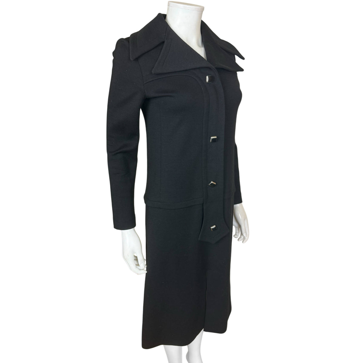 Pierre Cardin black wool jersey dress circa 1970, three-quarter front view showing architectural collar and fitted silhouette
