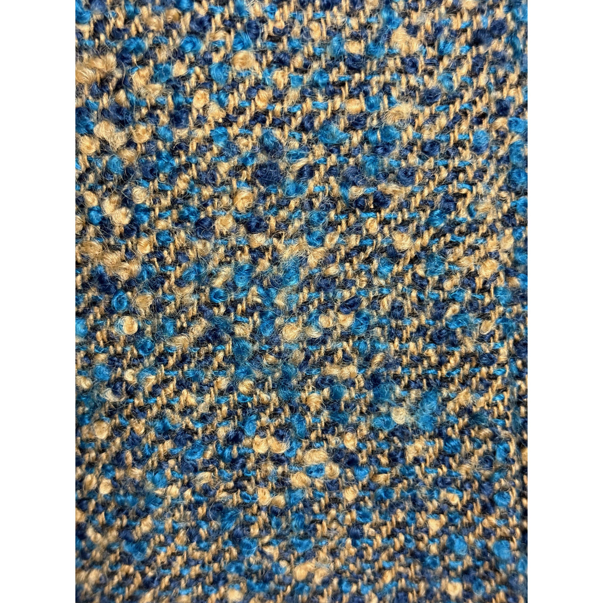 Vintage wool bouclé fabric close-up in teal blue navy and camel