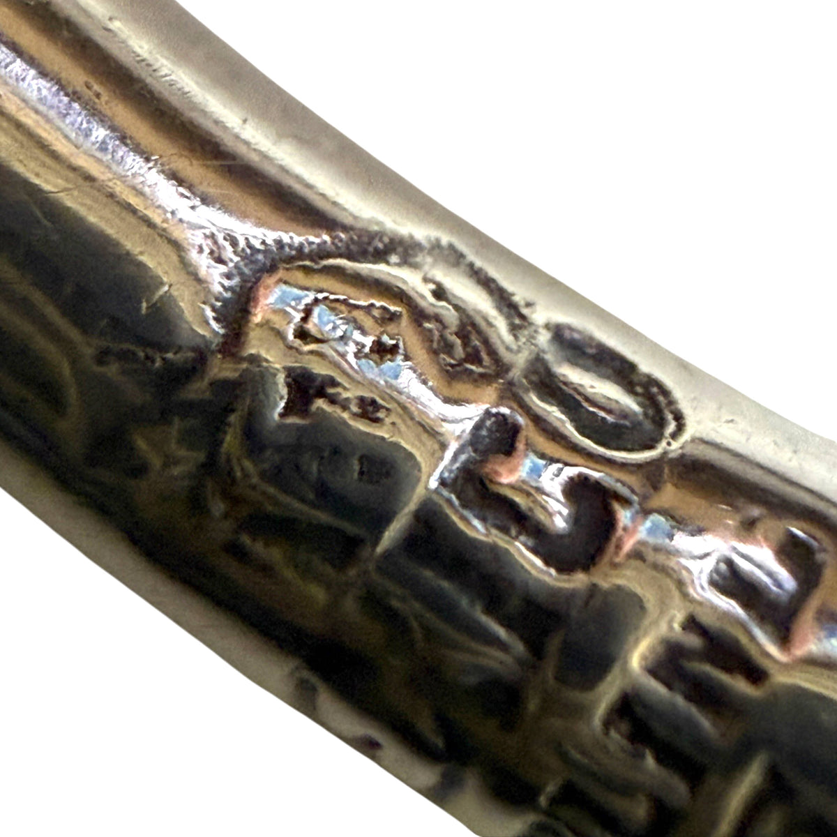 Close-up of Mexican Eagle 78 assay hallmark on sterling silver bracelet