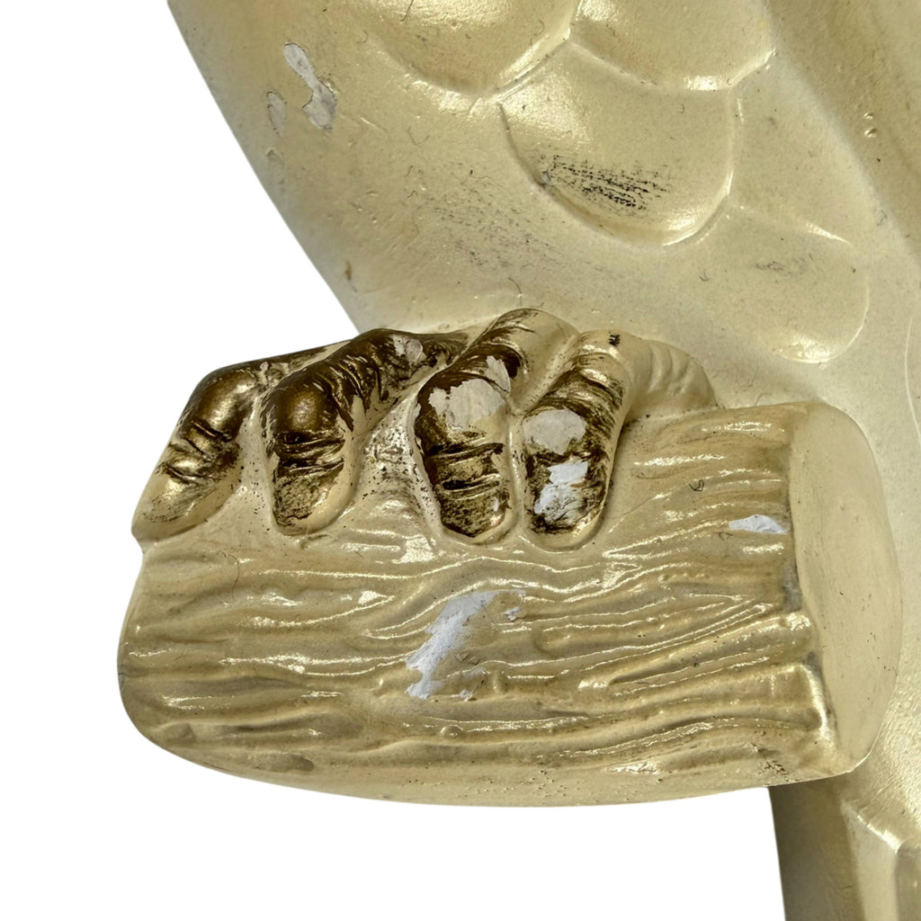 Close-up of surface finish loss on the claws and branch of the left-facing Miller Studio chalkware cockatoo