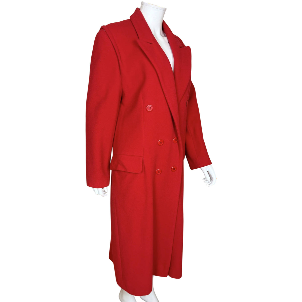Three-quarter front view of vintage 1980s Mondi red coat with double-breasted buttons and flap pockets.