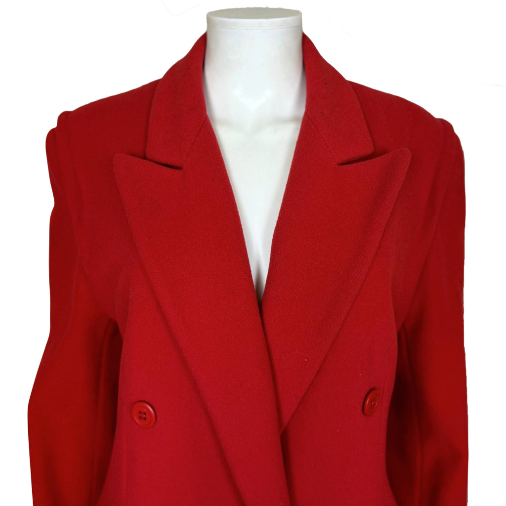 Close-up of Mondi red coat showing oversized pointed lapels, notched collar and tailored shoulders