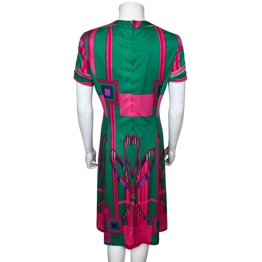 Back of vintage Montreux Knitting Swiss jersey dress showing centre back zipper and geometric pink and green print