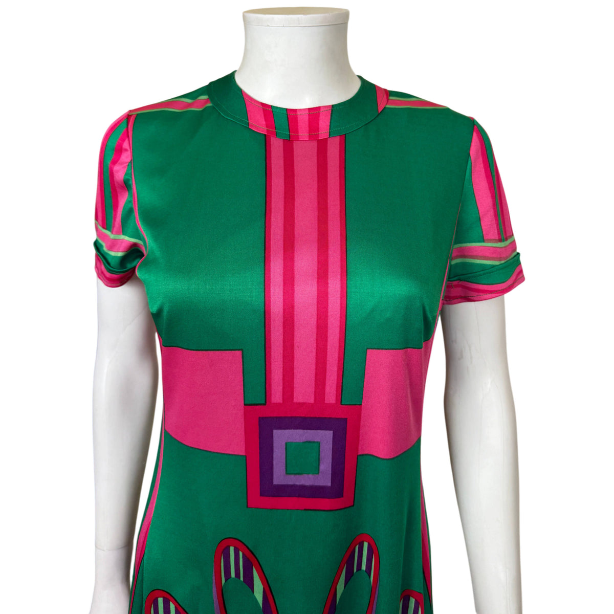 Close-up of Montreux Knitting dress showing round neckline, short sleeves and striped geometric bodice print