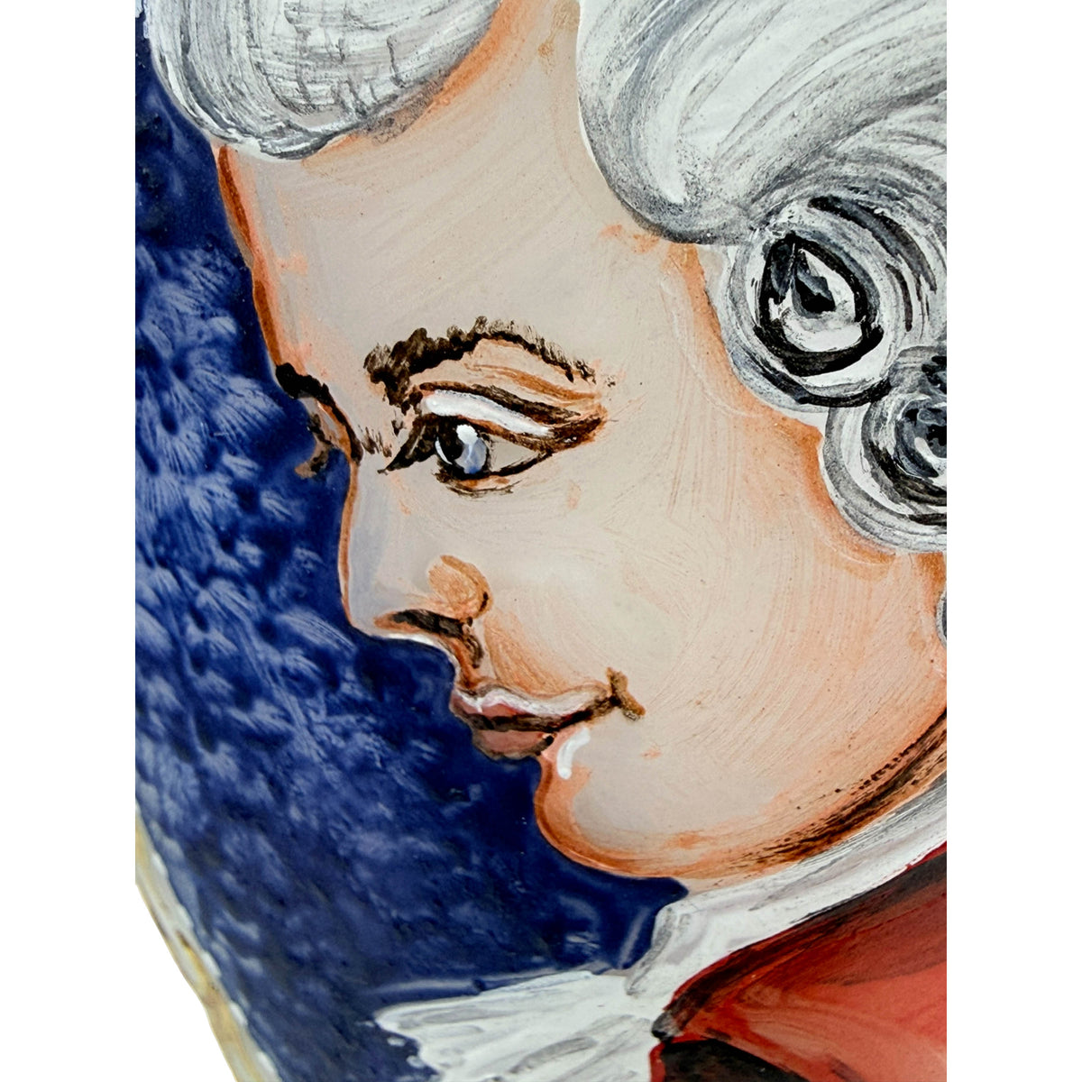 Close-up of hand-painted Mozart portrait on glass vase