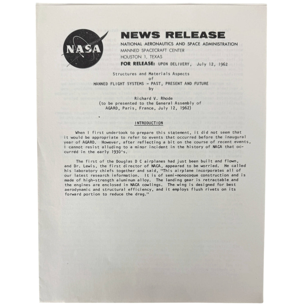 A vintage NASA press release document on white paper, showing the NASA logo and text about the Manned Spacecraft Center and Manned Flight Systems