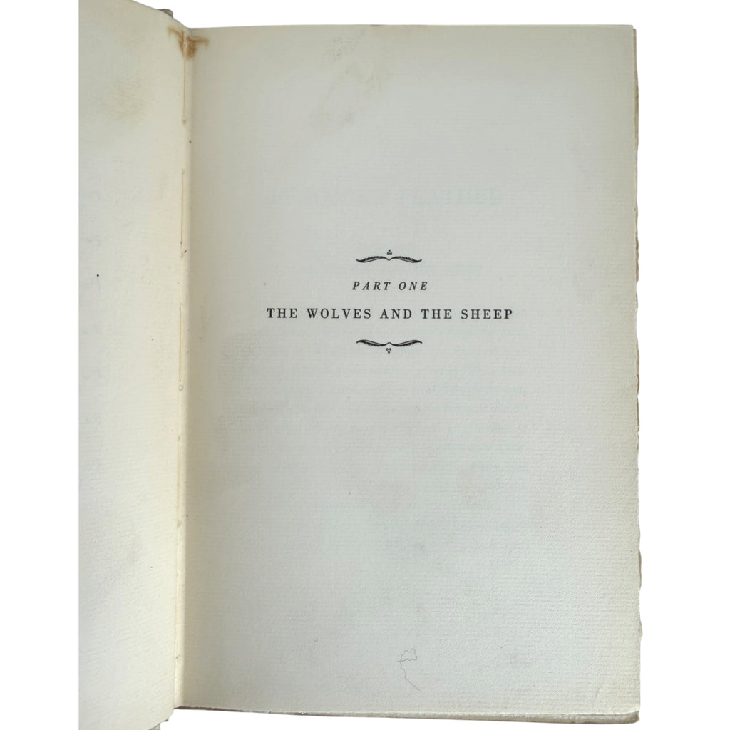 An open vintage book showing the title page for 'Part One: The Wolves and the Sheep' in black serif text on aged, off-white paper.