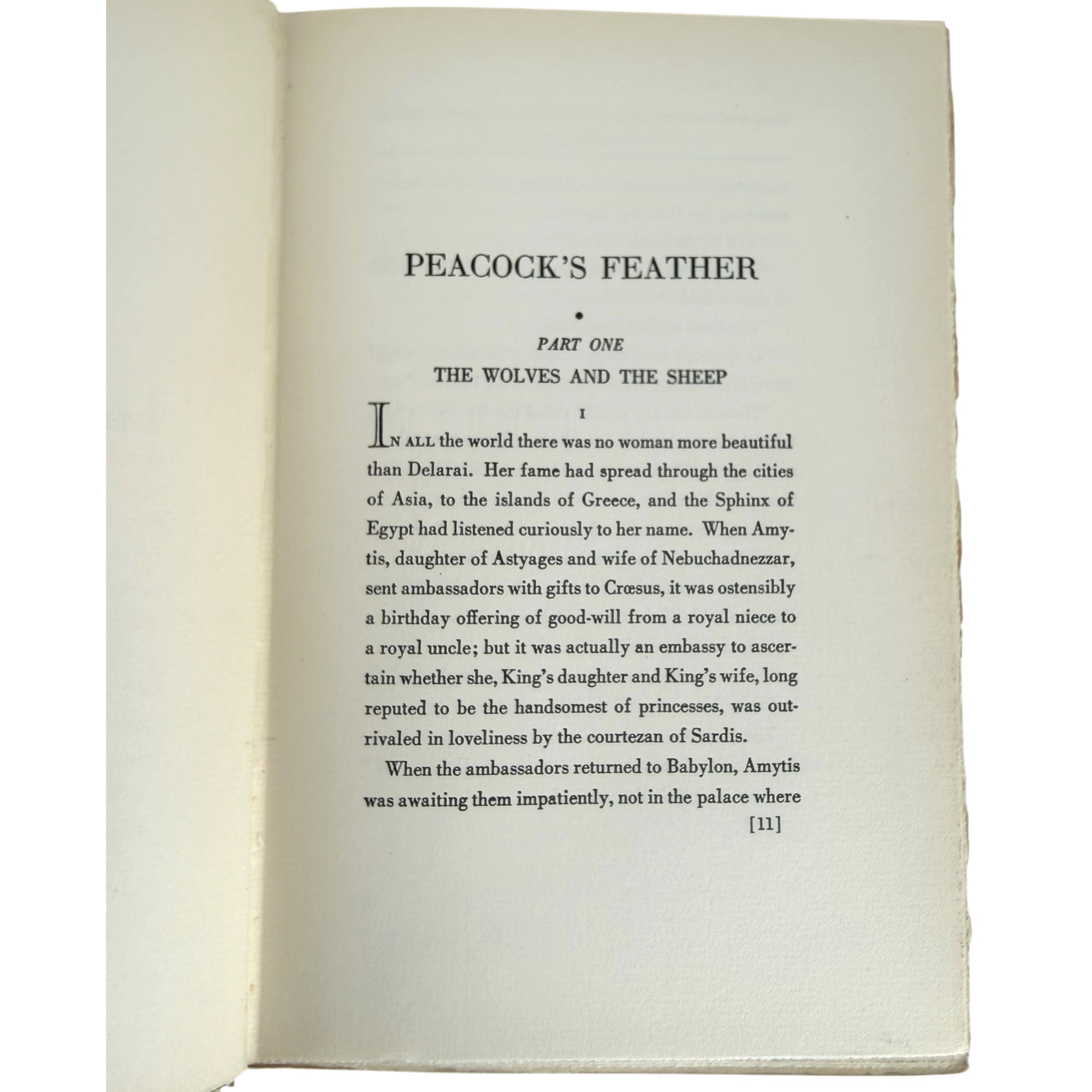 An open vintage book showing the first page of 'Peacock's Feather: Part One The Wolves and the Sheep' printed in black serif text on aged off-white paper.