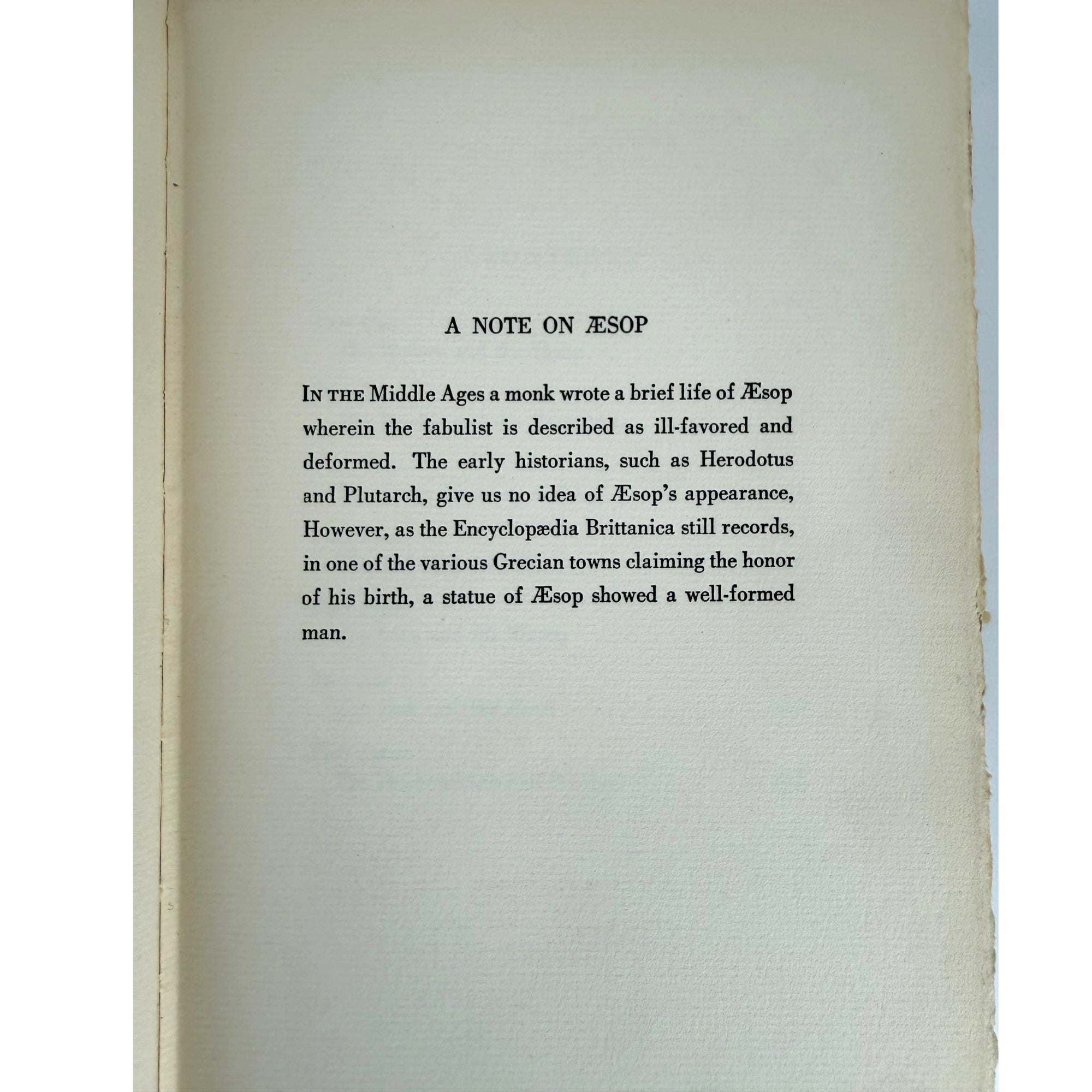 A printed page from a book or booklet showing the title 'A NOTE ON ΞSOP' and a block of black text on an off-white page, photographed against a white background.