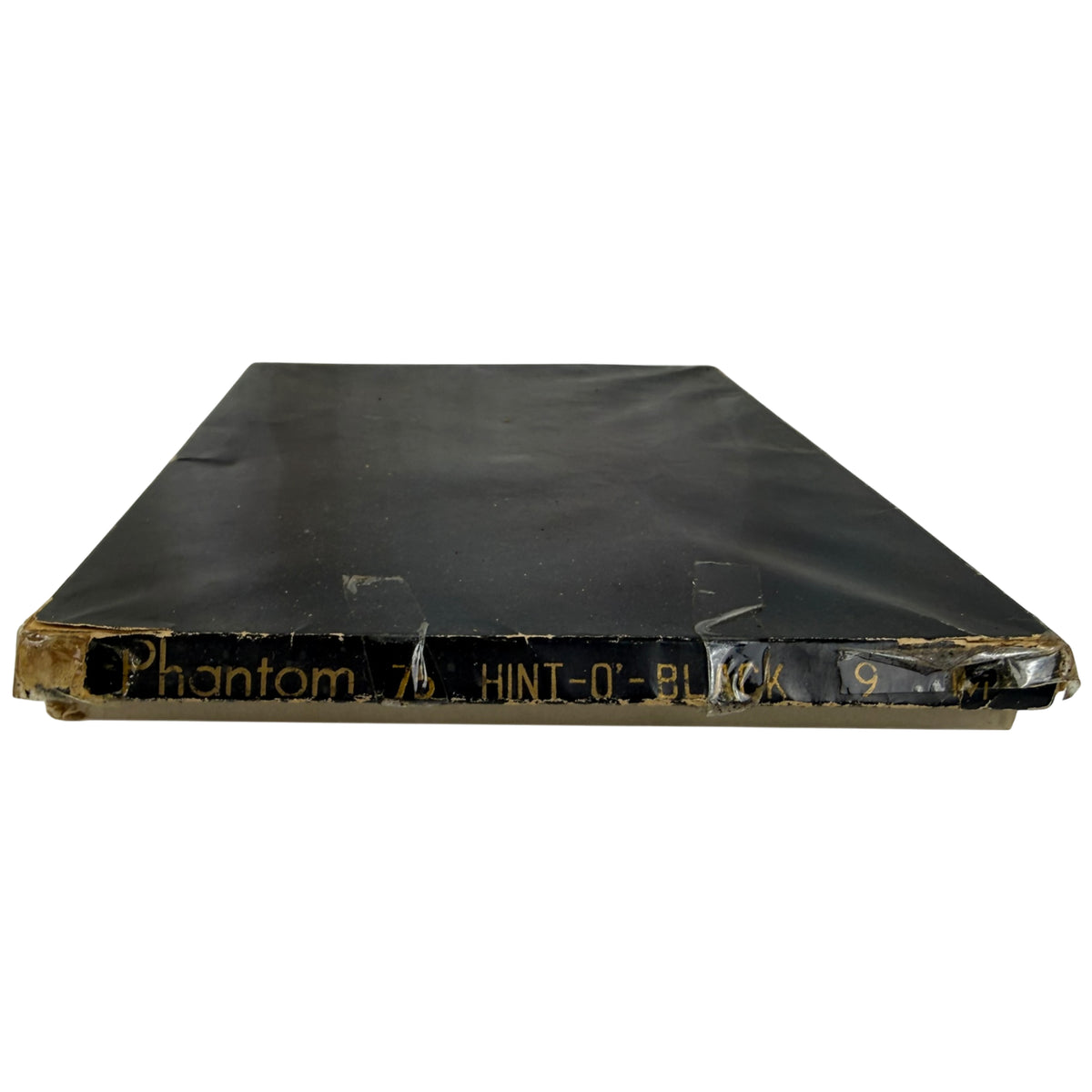 A vintage black box containing nylon stocking with gold printed text reading 'Phantom 76 HINT-O-BLACK 9' on the end edge