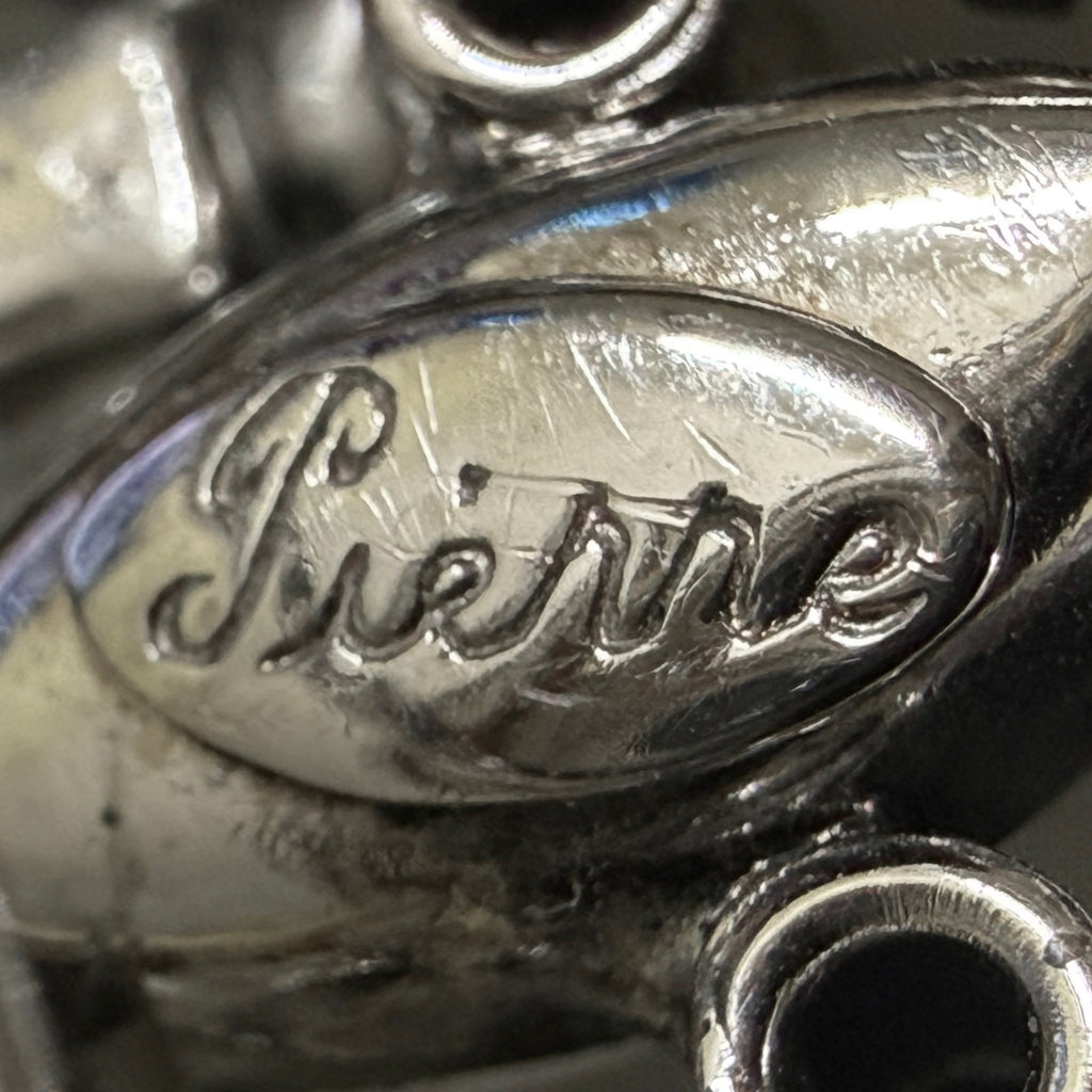 Close-up of Pierre signature on vintage rhinestone brooch