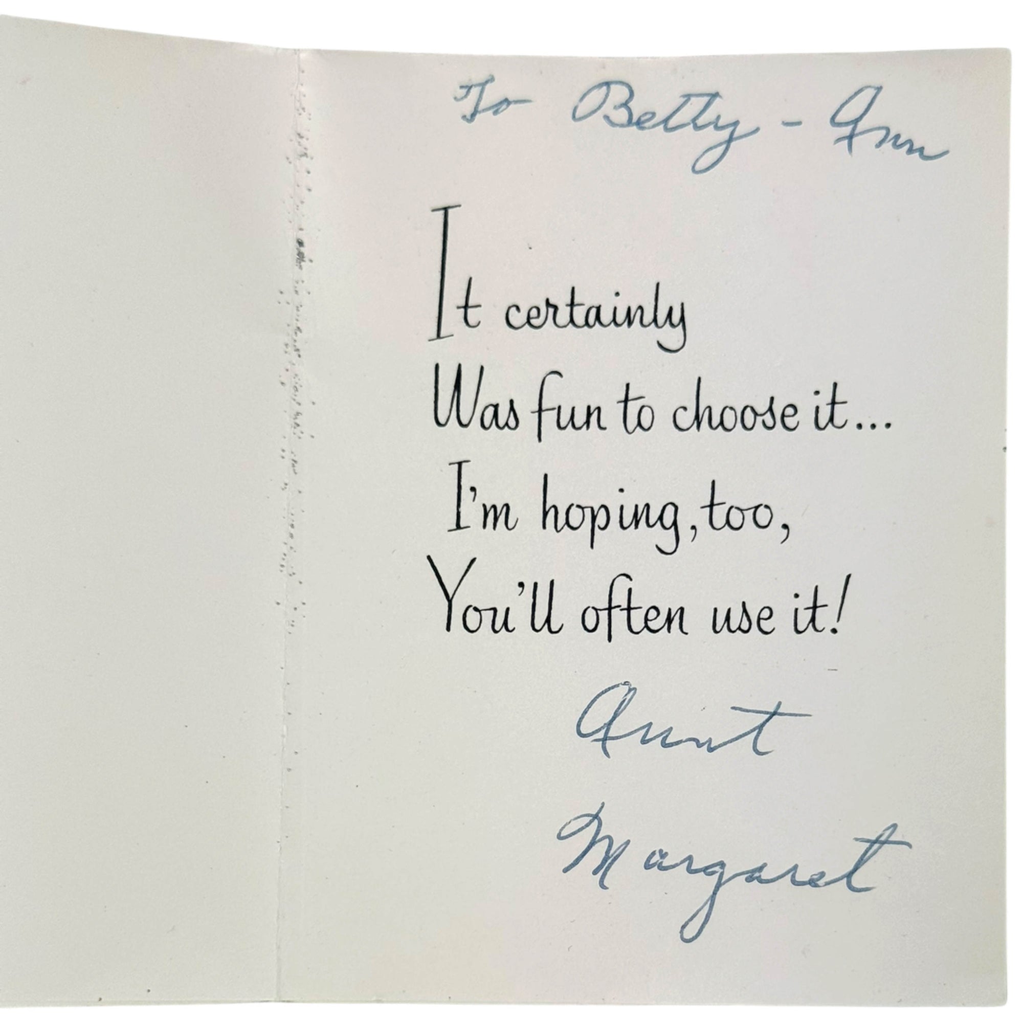 An open vintage paper card with handwritten text addressed 'To Betty - Aunt Margaret'. The card is photographed against a neutral background, showing black and blue ink writing on aged off-white paper.