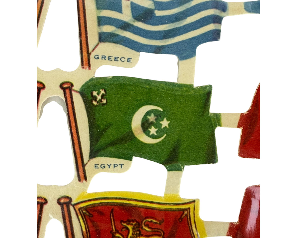 A close-up of a diecut flag of Egypt part of a Raphael Tuck Relief Scraps sheet